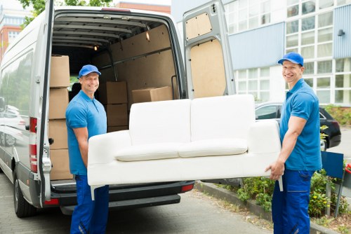 Professional furniture removals team in Greenwich loading a van
