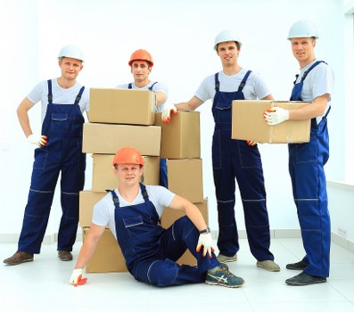 Moving crew handling packed boxes during a property relocation