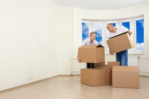 Moving team safely carrying furniture into a Greenwich flat