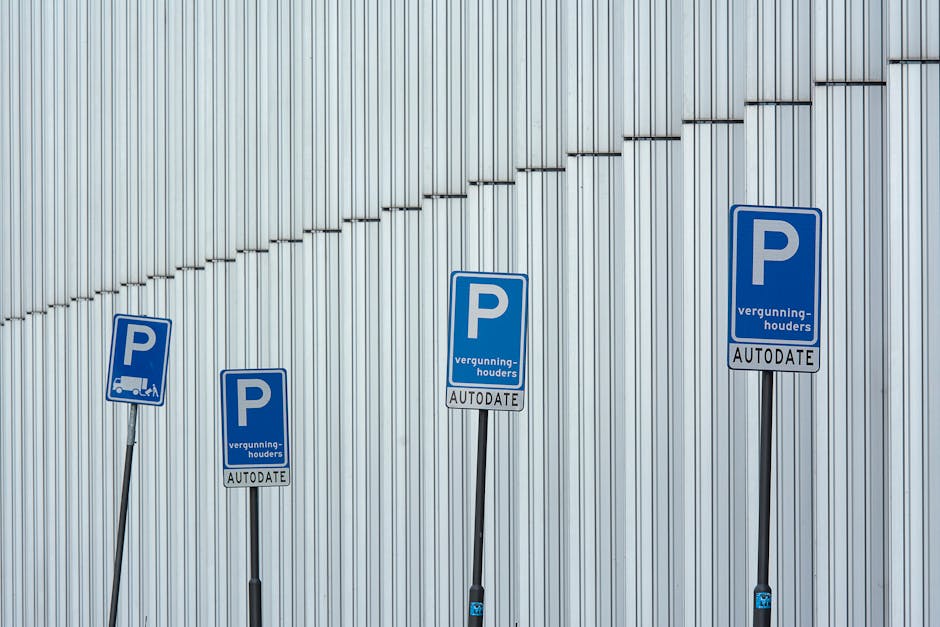 A parking restriction sign mounted on a metal pole outdoors at night, displaying a red circle with a diagonal line crossing out the letter 'P' and the message 'SUBJECT TO TICKET' beneath it. The sign 